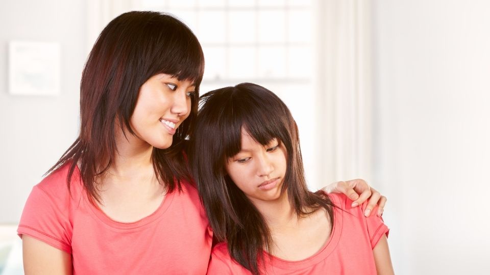 Asian Girl Consoling Sister
