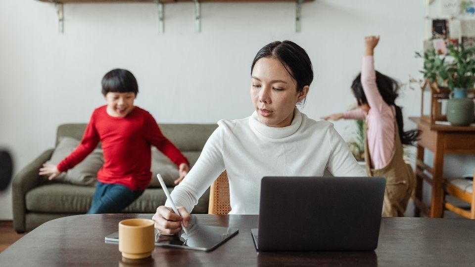 Busy Mom Working at Home with Kids