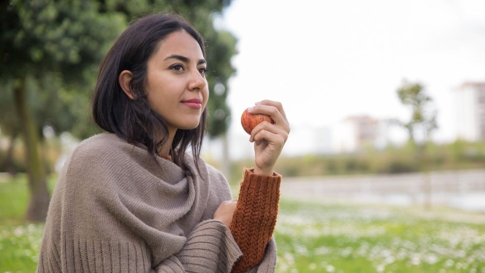 Girl Eating Apple Outdoors