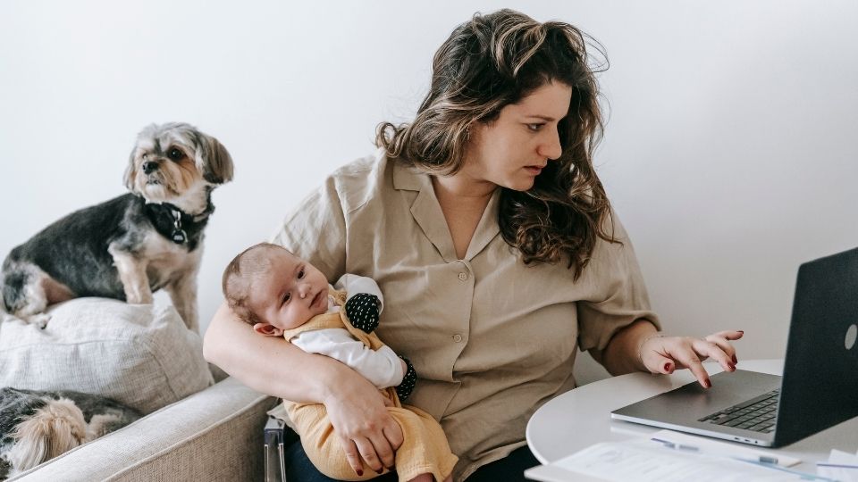 Busy Mom Working and Caring for Baby