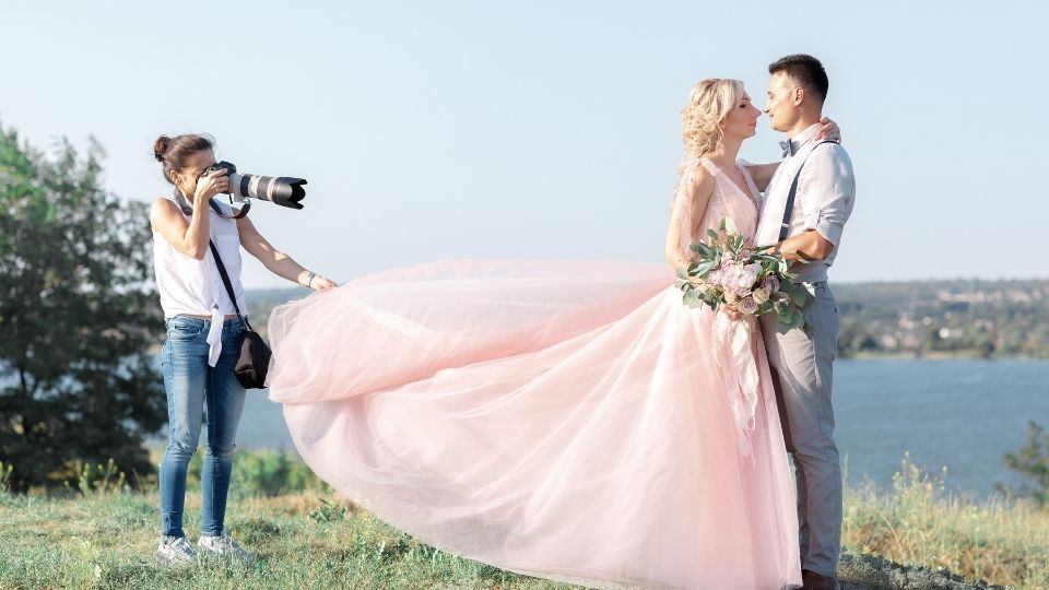 Female Wedding Photographer with Bride and Groom