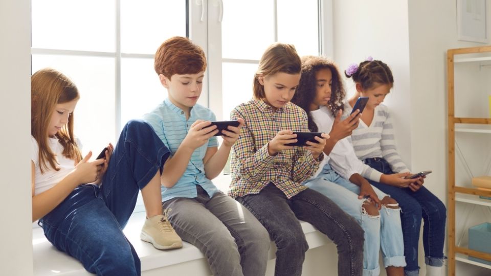 Group of Children Using Their Mobile Phones