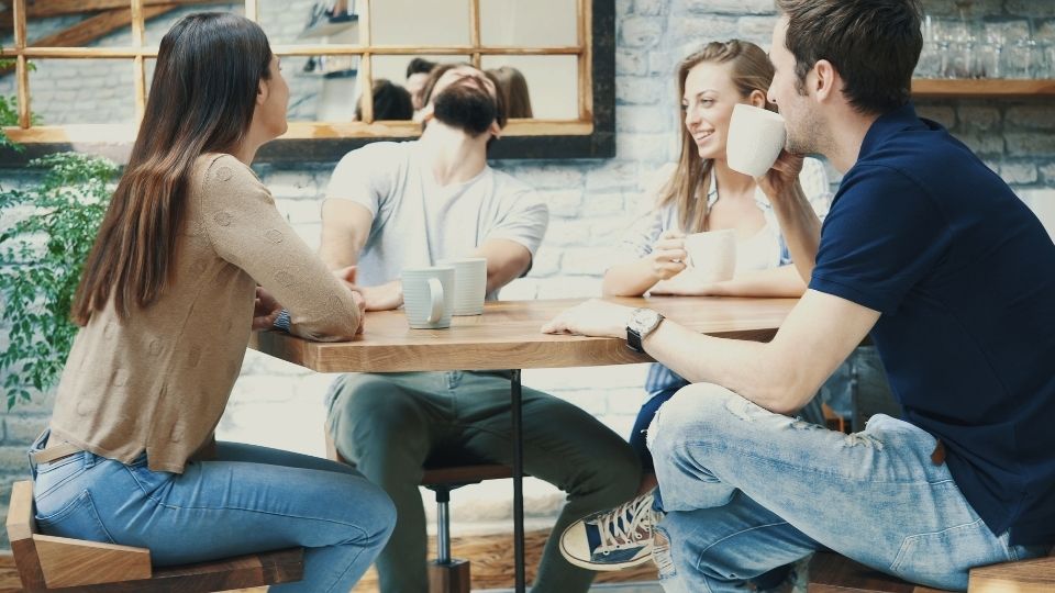 Group of Friends Laughing Over Coffee