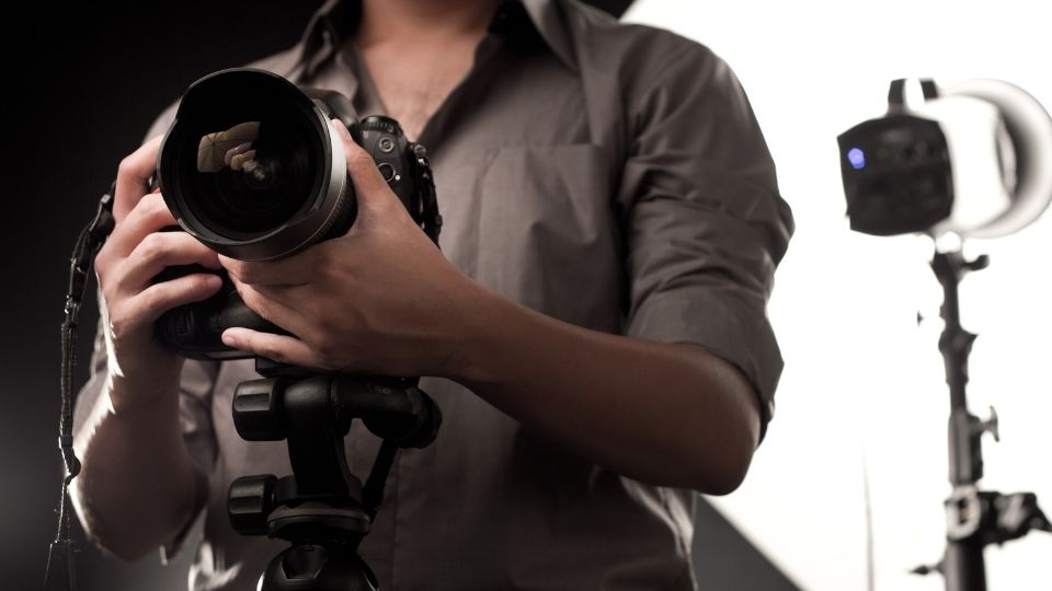 Professional Photographer Adjusting Lens